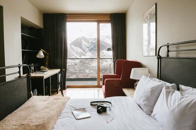 Rooms are neutral-toned, sleek and timber-clad. Courtesy Rooms Kazbegi