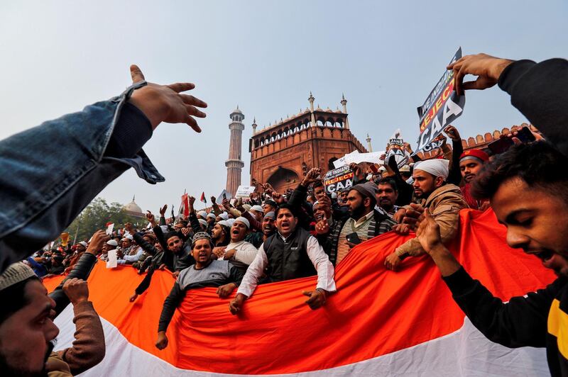 Demonstrators hold the national flag of India as they attend a protest against a new citizenship law, after Friday prayers at Jama Masjid in the old quarters of Delhi, India, December 20, 2019. REUTERS/Danish Siddiqui TPX IMAGES OF THE DAY