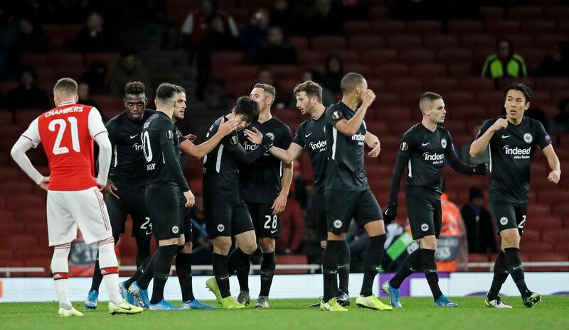 Frankfurt's Daichi Kamada, centre, is congratulated by teammates after scoring his side's first goal at the Emirates. AP