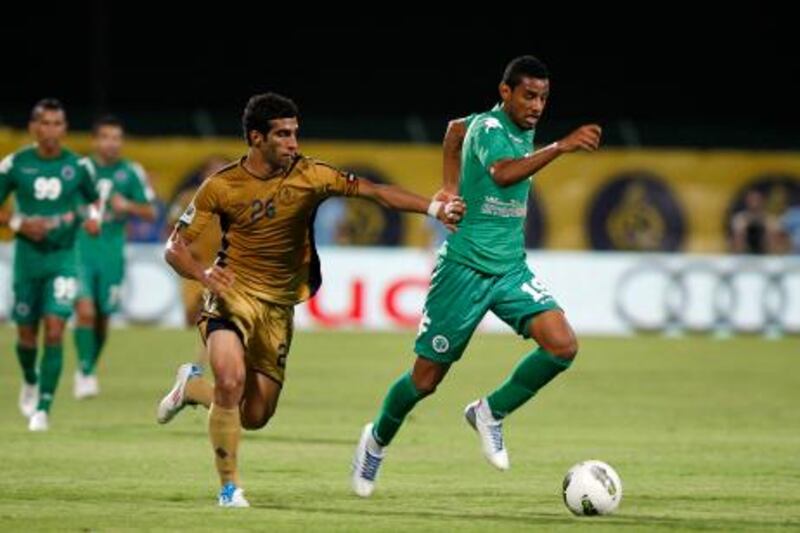 Dubai, United Arab Emirates, Oct 23 011, Al Shabab v Dubai,    (left) Dubai's #26 Ismaeil Ahmed  battles with Al Shabab's #19 Mohamed Ahmad at  Police Officers Club Stadium, Oct 23 2011  . Mike Young / The National