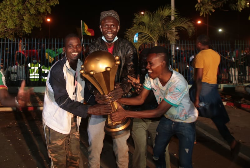 Senegalese football fans celebrate with a giant-sized replica of the Afcon trophy in Dakar, Senegal. EPA