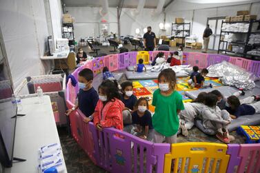 Young unaccompanied migrants, from ages 3 to 9, watch television inside a playpen at the US Customs and Border Protection centre. AP Photo