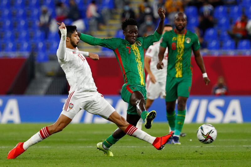UAE defender Mohamad Al Attas, left, and Mauritania's forward Idrissa Thiam vie for the ball.