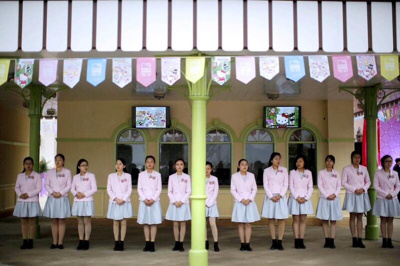 Attendants wait for guests during the inauguration ceremony of the Hello Kitty amusement park near Shanghai. The park will feature 11 Hello Kitty facilities, including a luxury resort decked out with plush pink furniture, chandeliers and bows. Carlos Barria / Reuters