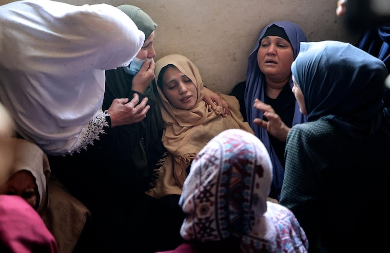 The mother of Palestinian boy Hussien Hamad, 11, is comforted by mourners during his funeral in Beit Hanoun in northern Gaza. AFP