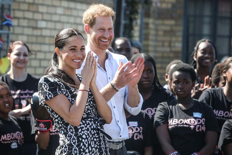 Prince Harry, Duke of Sussex and Meghan, Duchess of Sussex arrive for a visit to "Justice  desk", an NGO in the township of Nyanga in Cape Town, as they begin their tour of the region on September 23, 2019. Britain's Prince Harry and his wife Meghan arrived in South Africa on September 23, launching their first official family visit in the coastal city of Cape Town. The 10-day trip began with an education workshop in Nyanga, a township crippled by gang violence and crime that sits on the outskirts of the city. / AFP / POOL / POOL / Betram MALGAS

