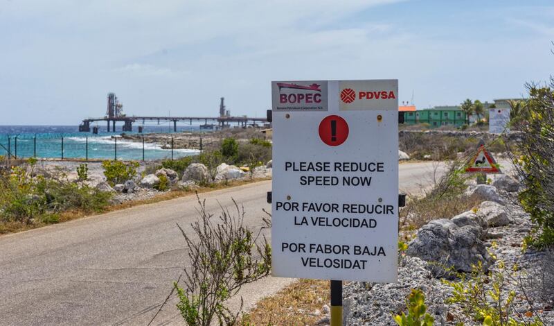 A warning sign stands at the entrance of the PDVSA/BOPEC Brasil Terminal in Rincon Bonaire on the Caribbean Netherlands island of Bonaire, Monday, May 7, 2018, where Venezuela refines and stores its heavy crude. U.S. oil giant ConocoPhillips is pressing for control of Venezuela's key offshore operations in the Caribbean, seeking to recoup $2 billion from a decade-old dispute with the nation struggling to feed its people, a source confirmed Monday. (AP Photo/Stephan Kogelman)