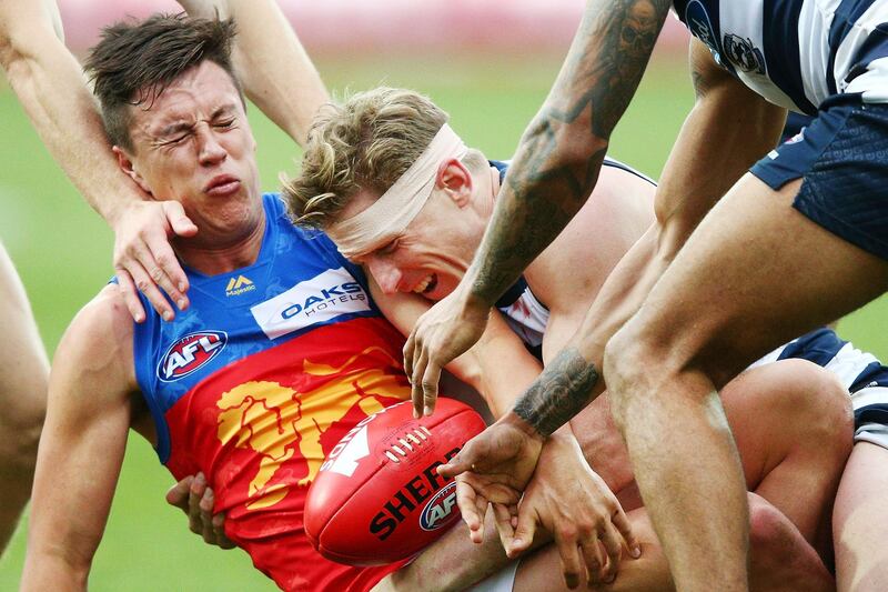 Scott Selwood of the Cats tackles Hugh McCluggage of the Lions during the round 19 AFL match between the Geelong Cats and the Brisbane Lions at GMHBA Stadium in Geelong, Australia. Michael Dodge/Getty Images