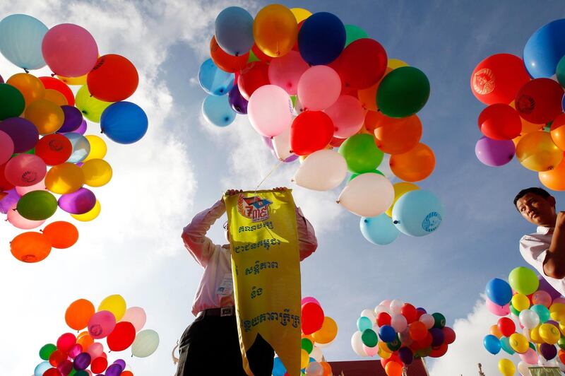 Cambodian students hold balloons during a ceremony in Phnom Penh, Cambodia. The ruling Cambodian People's Party marked its 39th anniversary of Victory Day, when they toppled the Khmer Rouge regime in 1979.  Mak Remissa / EPA