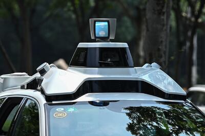 This photo taken on July 22, 2020 shows a Didi Chuxing autonomous taxi during a pilot test drive on the streets in Shanghai. Chinese entrants in the race to put autonomous vehicles on the road are bringing "robotaxis" online in hopes that a hired-car format can be the key to unlocking wide acceptance of the futuristic technology. - TO GO WITH AFP STORY IT-China-automobile-autonomous-computers,FOCUS by Beiyi Seow and Dan Martin
 / AFP / Hector RETAMAL / TO GO WITH AFP STORY IT-China-automobile-autonomous-computers,FOCUS by Beiyi Seow and Dan Martin
