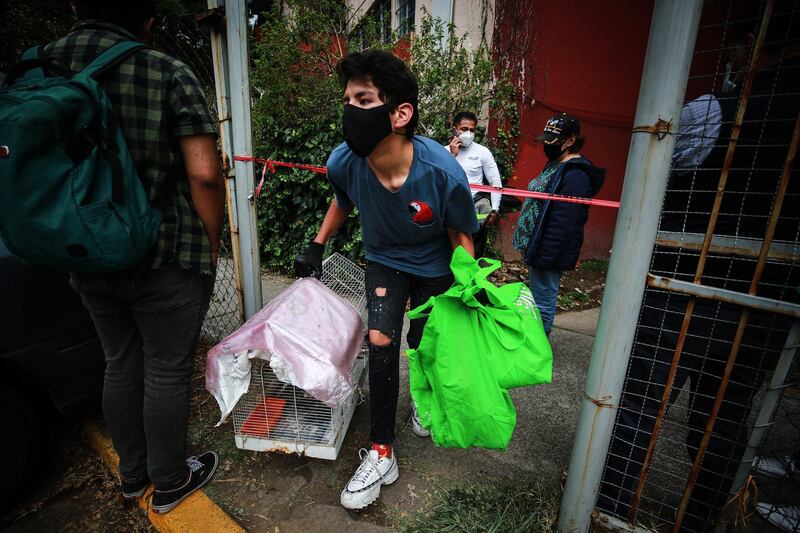 A resident takes his belongings from his apartment  in Mexico City. Getty Images