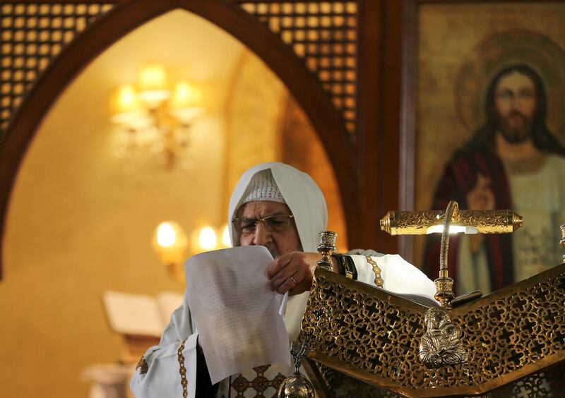 Egyptian Coptic priest Sawirs Marcos Saiwirs reads government instructions on preventing the spread of coronavirus during Sunday mass at Archangel Michael Church in Cairo, Egypt. REUTERS