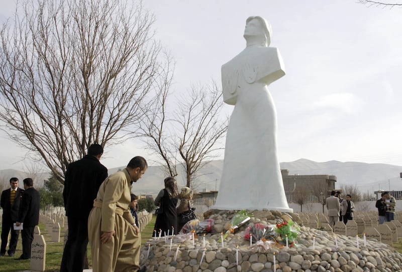 Iraqi Kurds light candles and lay flowers in the cemetery for the victims of the Halabja chemical attack carried out by Saddam Hussein in 1988. AFP