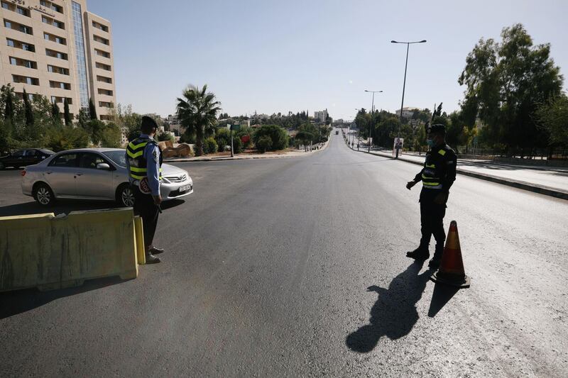 Jordanian police personnel guard at a checkpoint during the second day of a nationwide curfew, imposed for two days, amid fears of a rising number of coronavirus disease (COVID-19) cases in downtown Amman, Jordan. REUTERS