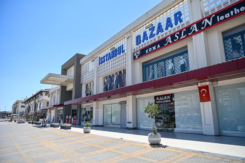 This picture taken on June 20, 2020 shows closed shops at Lara district in Antalya, a popular holiday resort in southern Turkey. In normal times, the tourist would have to get up at dawn to find a free sunbed on this beach of Antalya, a popular holiday resort in southern Turkey. Today even after a sleep in, the best locations are all available. The novel coronavirus pandemic has hit the tourism industry -- the backbone of the country's economy.  / AFP / Ozan KOSE
