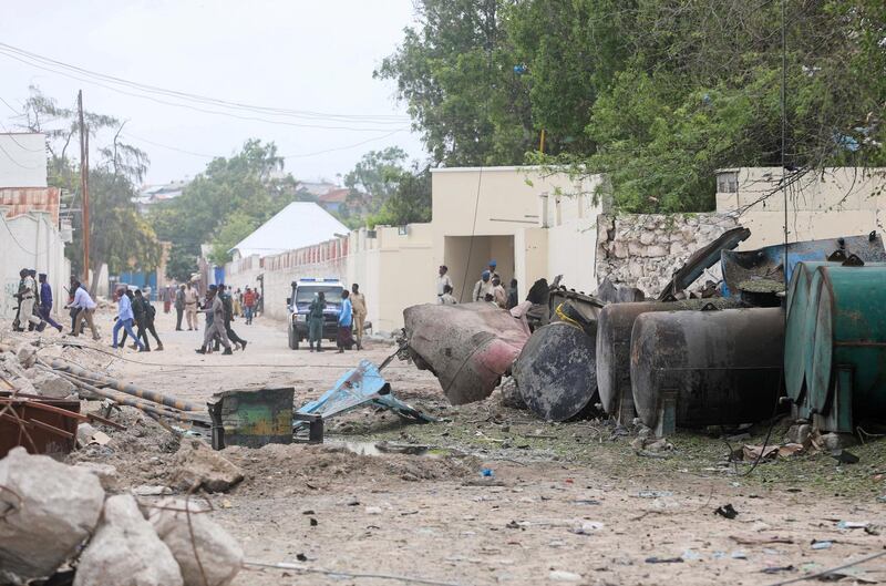 Somali policemen at the scene after a suicide car bomber drove into a checkpoint outside the port in Mogadishu. Reuters