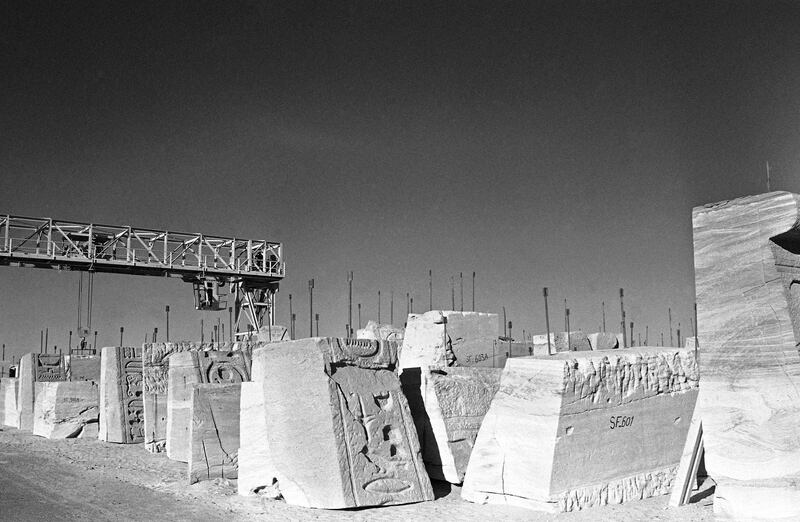 The results of three years of dismantling the temples of Abu Simbel in Egypt lie in a storage area behind the huge escarpment before being moved and re-assembled on higher ground. AP Photo