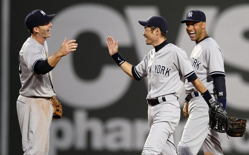 New York Yankees right fielder Ichiro Suzuki, centre, with his teammates. CJ Gunther / EPA