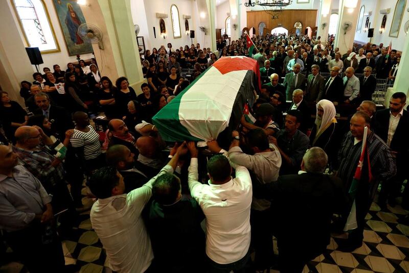Relatives and activists carry the body of Jordanian writer Nahed Hattar, who was shot dead, during his funeral in the town of Al-uheis near Amman, Jordan, September 28, 2016. REUTERS/Muhammad Hamed