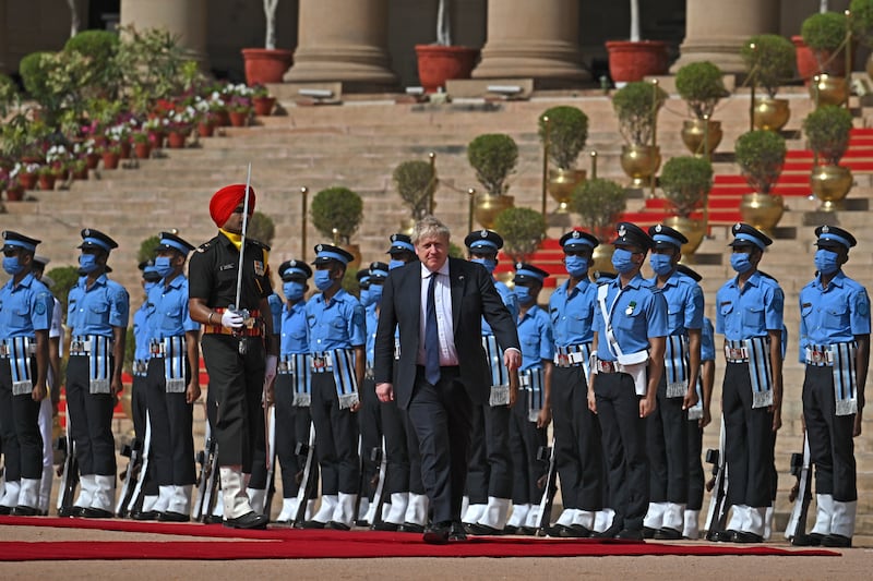 Boris Johnson inspects a guard of honour during a ceremonial reception at presidential palace Rashtrapati Bhavan in New Delhi. Getty Images