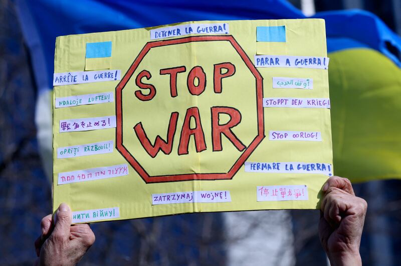 A placard is held up during an anti-war protest called 'Stand with Ukraine' in central Brussels, Belgium.  Reuters