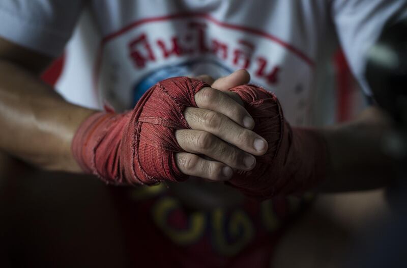World Boxing Council (WBC) mini-flyweight champion, Wanheng Menayothin, clasping his wrapped knuckles during an interview before a training session in Bangkok. Lillian Suwanrumpha / AFP