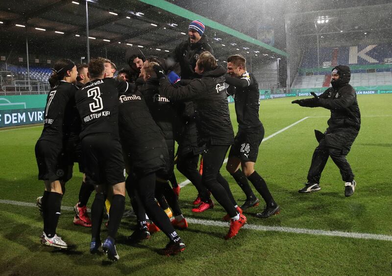 Kiel's players celebrate after beating Bayern Munich. AP