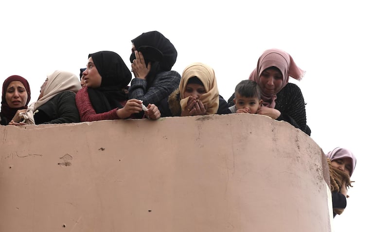 Spectators watch as Palestinians carry the body of Bader Nidal Nafleh (19) during his funeral, in the West Bank village of Qafen near Tulkarem city.  EPA