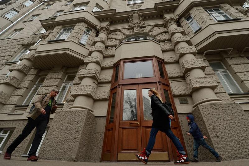 People walking past a building where unknown individuals broke into the flat of Onno Elderenbosch, a senior Dutch diplomat of the Netherlands mission. Kirill Kudryavtsey / AFP Photo 