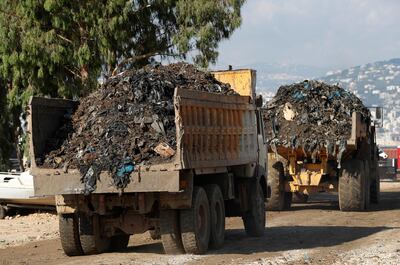 In this June 22, 2017, photo, trucks carry garbage to a new land reclamation site in Bourj Hammoud, east of Beirut, Lebanon. Environmentalists say a winter storm has pushed a wave of trash onto the Lebanese shore outside Beirut, stirring outrage over a waste management crisis that has choked the country since 2015. (AP Photo/Hussein Malla)