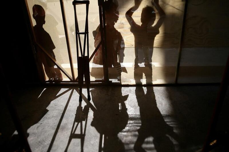 The shadows of crutches and children with special needs are seen on September 29, 2016, during a party for young victims of the Syrian conflict in the rebel-held town of Hamouriyeh, near Damascus, Syria. Bassam Khabieh / Reuters