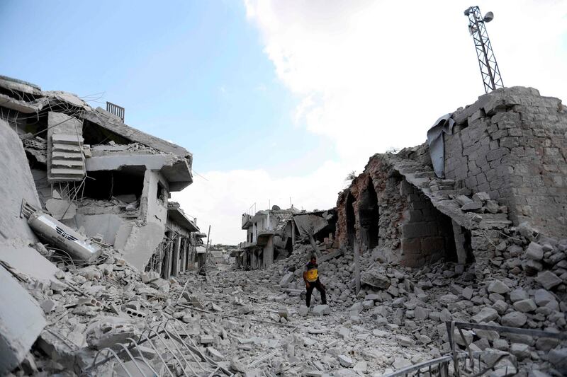 TOPSHOT - A picture taken on June 14, 2019, shows a man walking amidst the debris of destroyed buildings in the town of Ihsim, in Syria’s Idlib region. The Idlib region of some three million people is supposed to be protected from a massive regime offensive by a buffer zone deal that Russia and Turkey signed in September. But it was never fully implemented, as jihadists refused to withdraw from a planned demilitarised zone. / AFP / OMAR HAJ KADOUR
