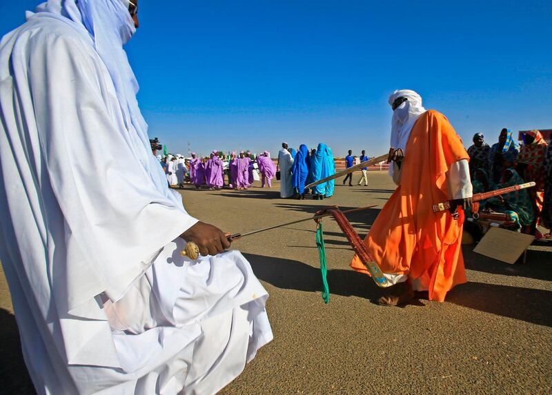 Displaced Sudanese welcome Sudan's prime minister in El-Fasher, the capital of the North Darfur state. AFP