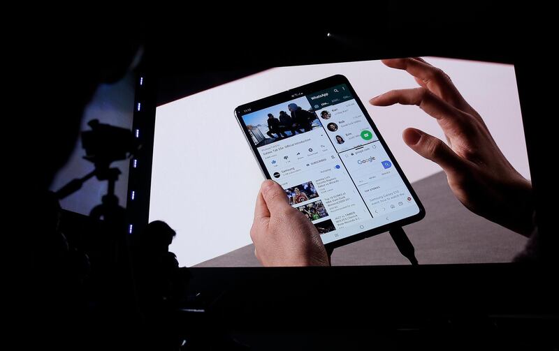 Features of the new Samsung Galaxy Fold smartphone are displayed during an event Wednesday, Feb. 20, 2019, in San Francisco. Samsung is hailing the 10th anniversary of its first smartphone with three new models that seem unlikely to reverse a sales slump in an industry recycling the same ideas. The S10 line-up unveiled Wednesday in San Francisco all boast fancy cameras, sleek screens covering the entire front of the device and at least 128 gigabytes of storage, the most important features to consumers looking for a new smartphone. (AP Photo/Eric Risberg)