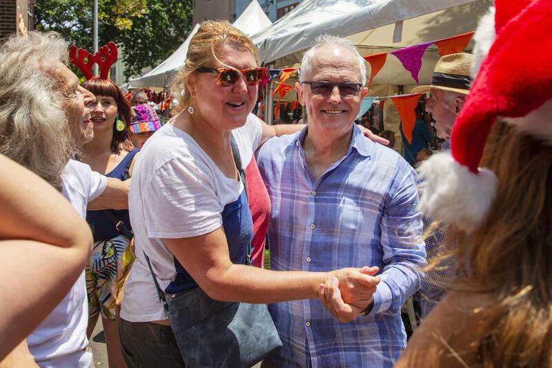 Former prime minister Malcolm Turnbull dances with locals at the Wayside Chapel Christmas Lunch in Sydney, Australia. Getty Images
