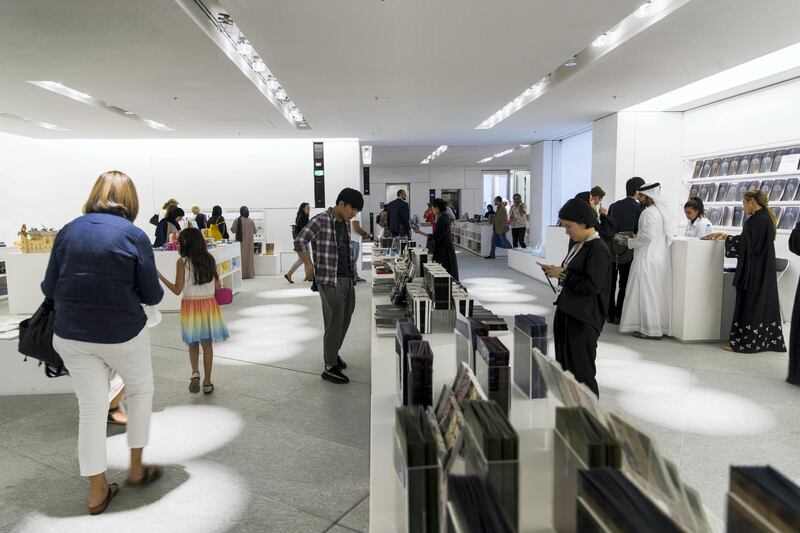 Abu Dhabi, United Arab Emirates, November 11, 2017:    Visitors in the boutique on opening day at the Louvre Abu Dhabi on Saadiyat Island in Abu Dhabi on November 11, 2017. Christopher Pike / The National

Reporter: James Langton, John Dennehy
Section: News