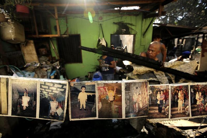 Family picture albums are seen hanging out to dry following a fire that razed a slum area in Quezon city, east of Manila, Philippines. Four people were reported hurt and more than 100 families were left homeless after a fire razed their houses. Ritchie B.Tongo / EPA