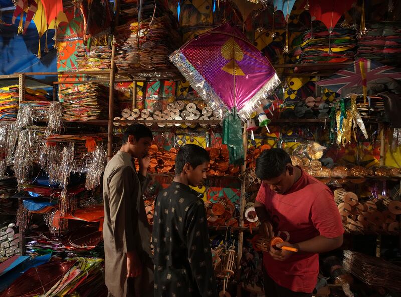 People shop for kites, to take part in good-natured kite-fighting competitions as part of Makar Sankranti celebrations. AP
