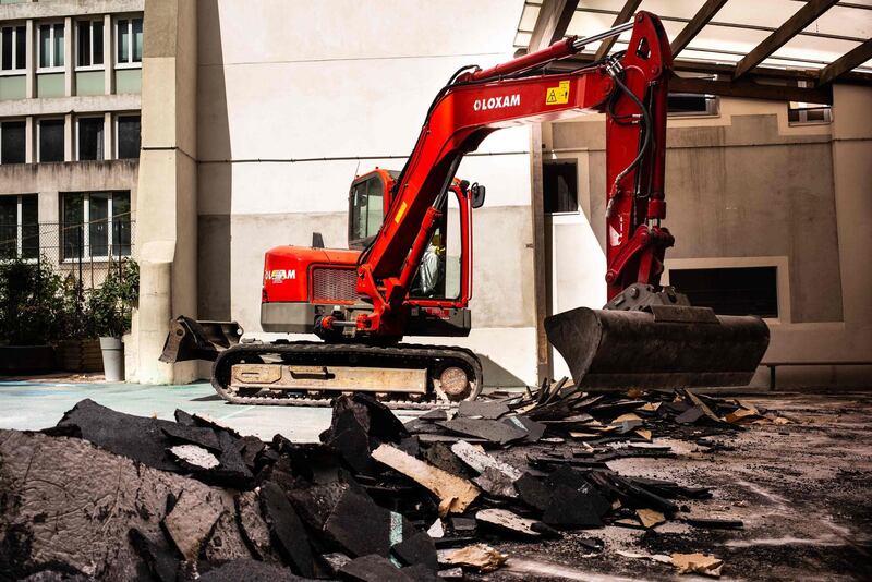 An excavator removes the ground of Saint Benoit elementary school on August 8, 2019 during a clean-up operation over lead poisoning fears. AFP