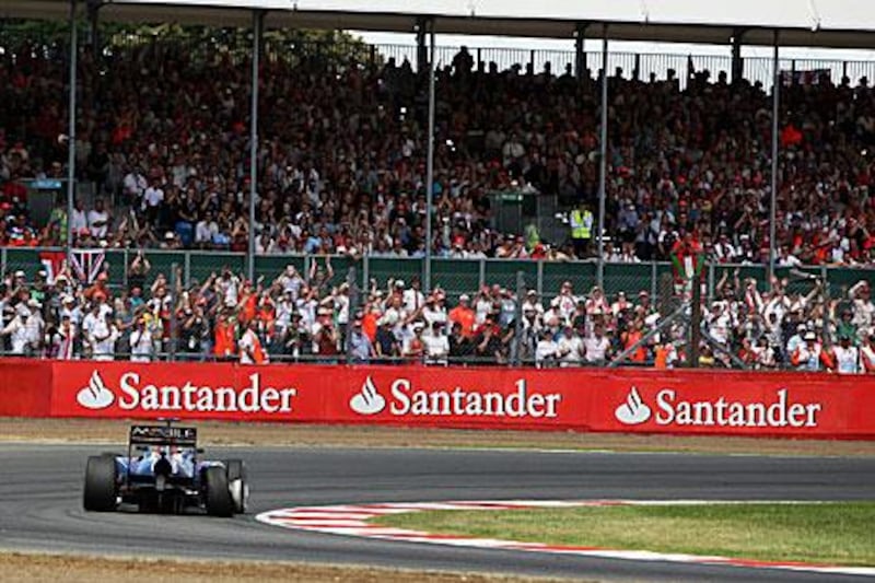 Spectators at last year’s British Grand Prix at Silverstone watch Sebastian Vettel in action in his Red Bull Racing car. A crowd of 120,000 attended that race, and a similar crowd is expected for this Sunday’s race, making it one of the most well attended sporting events in Britain.