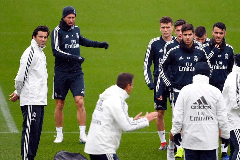 Santiago Solari watches on as his coaching staff give instructions to Real Madrid players. AFP