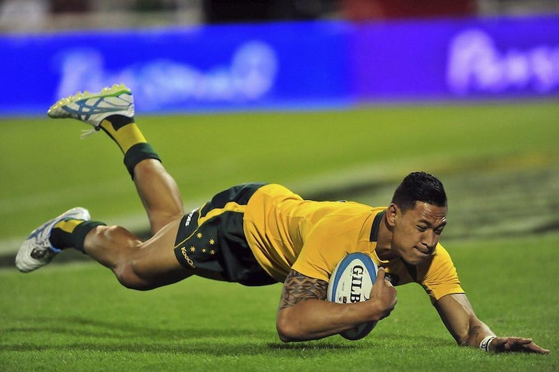 Iisrael Folau as he scores one of his three tries in Australia's defeat of Argentina on Sunday. Daniel Salvatori / Reuters