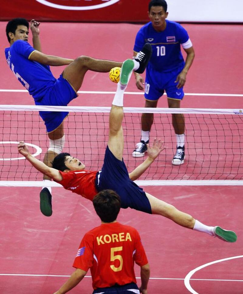 Thailand's Sahachat Sakhoncharoen, left, attempts to block a strike by South Korea's Kim Young-man during their men's team sepak takraw game at the Bucheon Gymnasium during the Asian Games in Incheon, South Korea, on September 23, 2014. Jason Reed / Reuters