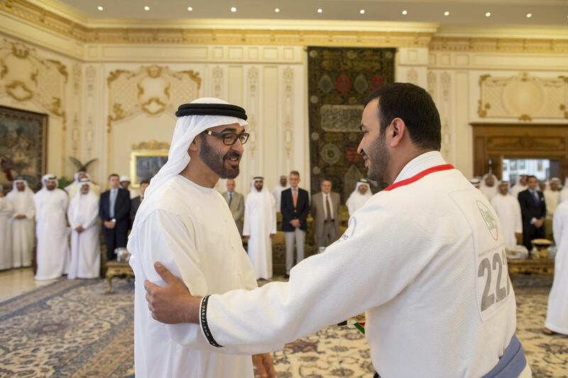 Sheikh Mohammed bin Zayed, Crown Prince of Abu Dhabi and Deputy Supreme Commander of the UAE Armed Forces, left, receives a UAE Jiu-Jitsu participant, who won a medal at the Arabian Gulf Jiu-Jitsu Cup. Ryan Carter / Crown Prince Court — Abu Dhabi 