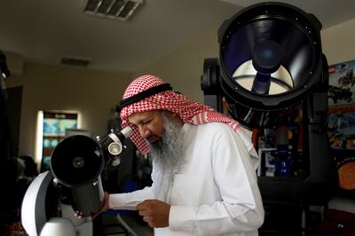 July 7, 2010 / Abu Dhabi / (Rich-Joseph Facun / The National) Hasan Ahmad Al Hariri (CQ), Chief Executive Officer of the Dubai Astronomy Group, displays one of several telescopes at his office, Wednesday, July 7, 2010 in Dubai. 
