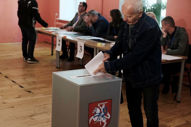 A man casts his vote in Vilnius, Lithuania. Turnout was 59 per cent, the highest in nearly three decades. EPA