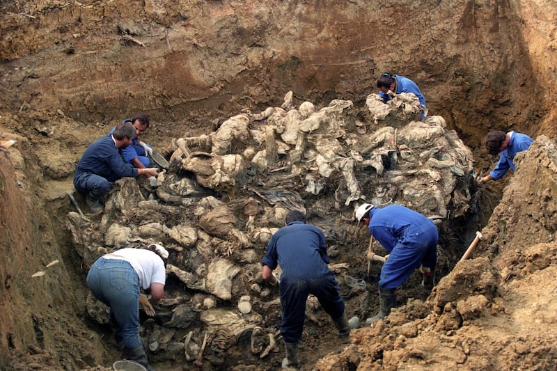 Investigators of the International War Crimes Tribunal at the mass grave where they discovered the remains of more than 100 executed people outside the village of Pilica, Bosnia and Herzegovina, September 18, 1996. EPA