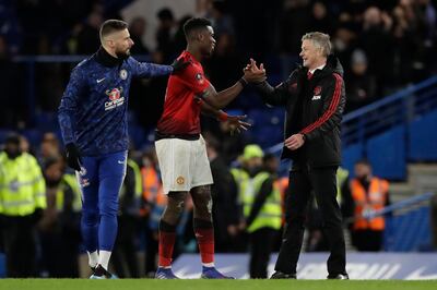 Manchester United caretaker head coach Ole Gunnar Solskjaer, right, celebrates with Paul Pogba, center, at the end of the English FA Cup fifth round soccer match between Chelsea and Manchester United at Stamford Bridge stadium in London, Monday, Feb. 18, 2019. Manchester United won 2-0. (AP Photo/Matt Dunham)