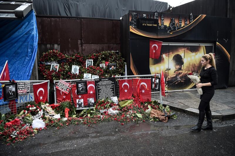 A woman lays flowers by a makeshift memorial in front of the Reina nightclub in Istanbul on January 17, 2017, a day after Turkish police arrested the suspected attacker.
A 34-year-old Uzbek man suspected of mowing down 39 people at an Istanbul nightclub on New Year's Eve confessed today to the massacre, Turkish authorities said. In a dramatic assault in the early hours of Tuesday morning, Turkish police raided an Istanbul apartment and detained Abdulgadir Masharipov after a massive weeks-long manhunt.  / AFP PHOTO / OZAN KOSE