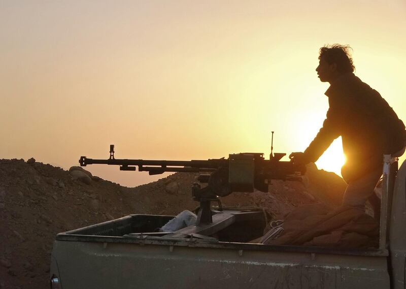 (FILES) In this file photo a combatant mans a heavy machine gun as forces loyal to Yemen's Saudi-backed government clash with Huthi rebel fighters around the strategic government-held "Mas Camp" military base, in al-Jadaan area about 50 kilometres northwest of Marib in central Yemen, on November 22, 2020.  Key US lawmakers on January 11, 2021 urged a quick reversal of outgoing Secretary of State Mike Pompeo's branding of Yemen's Huthis as a terrorist group, saying he had worsened a humanitarian crisis. "The designation of the Huthis as a terrorist organization is a death sentence for thousands of Yemenis", said Senator Chris Murphy, a prominent member of President-elect Biden's Democratic Party. "It will cut off humanitarian aid, make peace talks nearly impossible and empower Iran. Biden should reverse this policy on day one," he wrote on Twitter.
 / AFP / -
